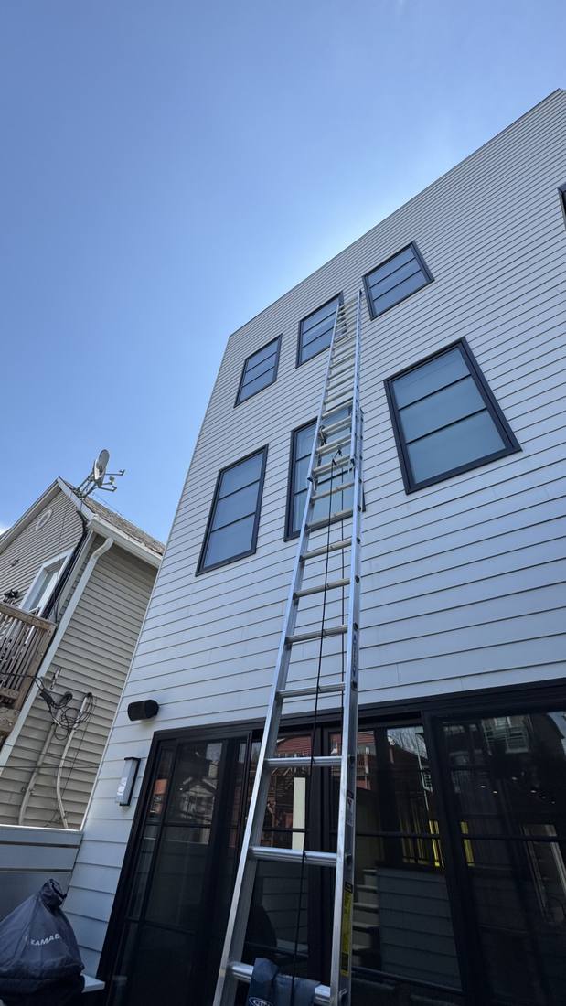 Exterior window cleaning on a three-story home